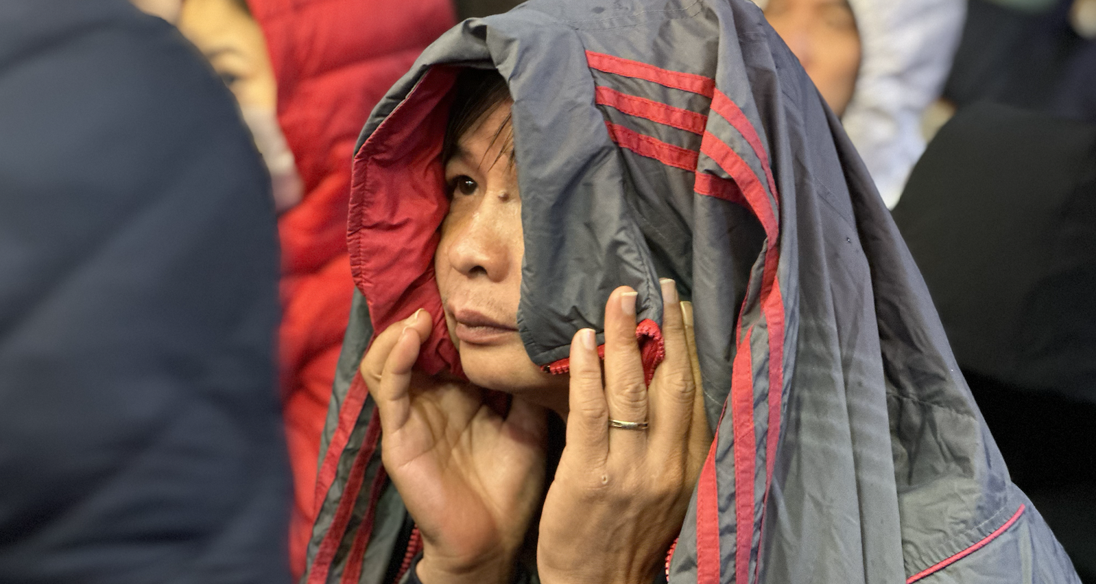 3am, people huddled in the cold rain waiting to buy gold for God of Wealth