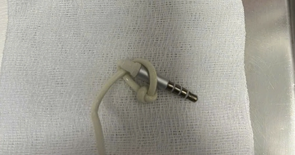 Headphone jack and cable in young man's private area