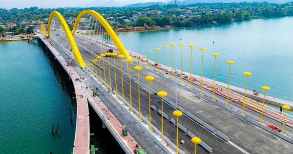 Primer plano del puente de arco de acero con sistema de iluminación "sombrilla dorada real" a punto de abrirse al tráfico.