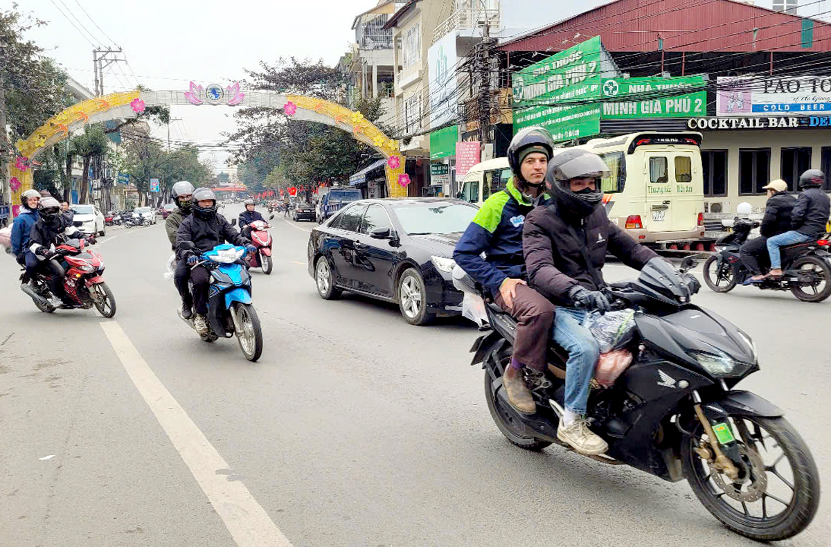 Rural workers work as motorbike drivers taking tourists to experience Ha Giang.