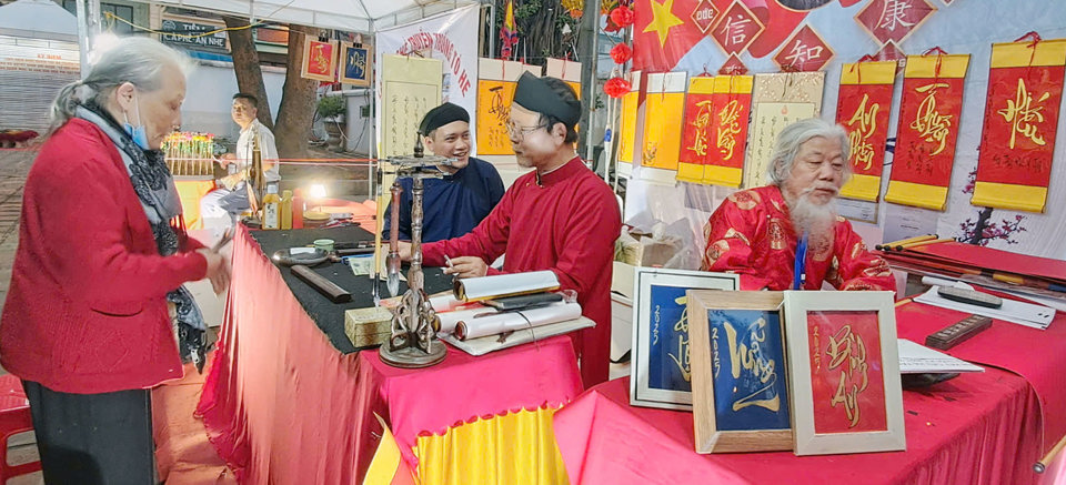 Présentation de l'art de la calligraphie aux touristes lors de la cérémonie d'ouverture du programme « Hanoi Tourism Welcomes 2025 - Get on Hanoi 2025 ». Photo : Hoai Nam