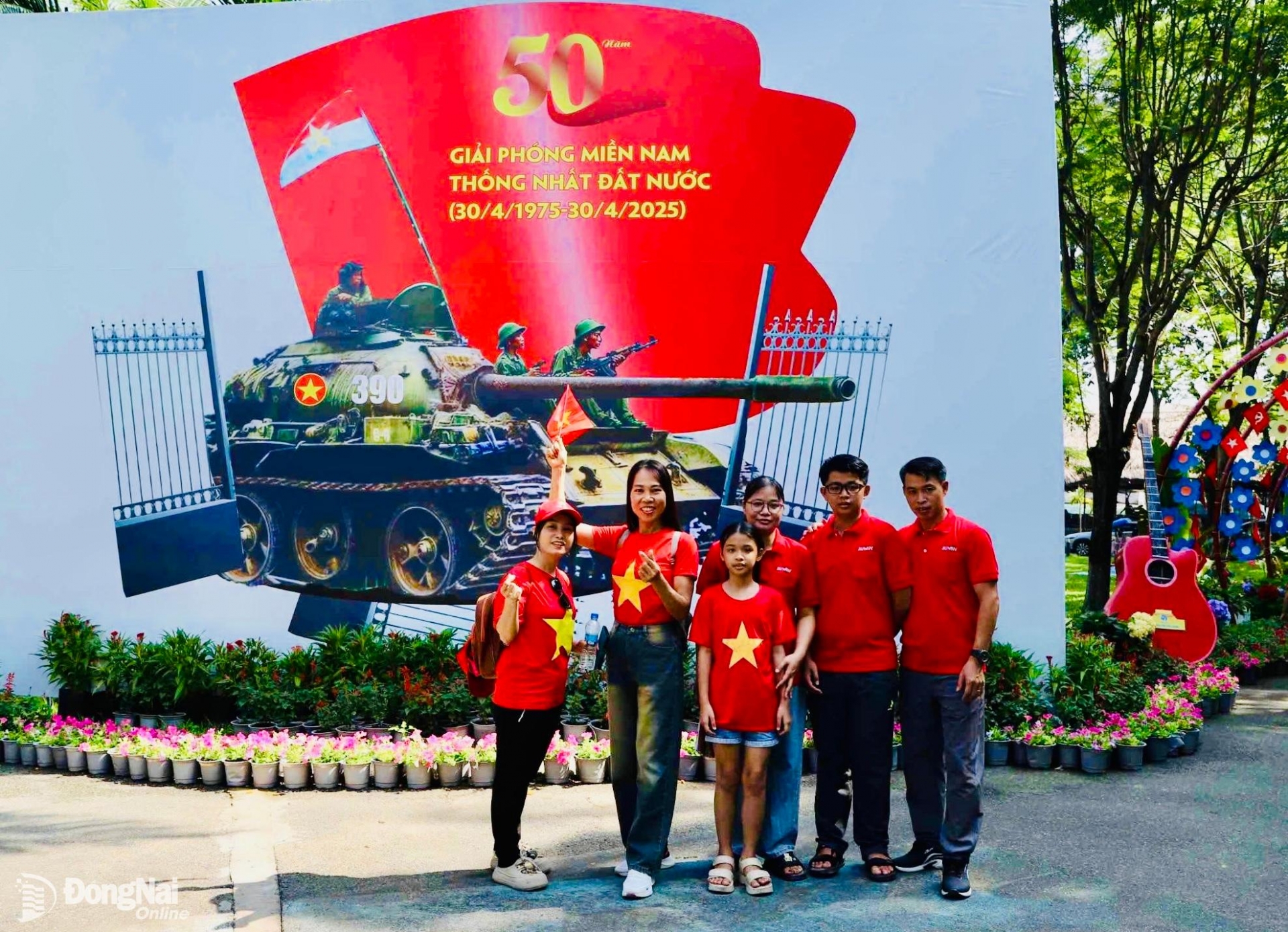 Một gia đình mặc đồ đỏ sao vàng đến vui chơi tại Khu du lịch Bửu Long chụp hình tại biểu tượng giây phút xe tăng tiến vào Dinh độc lập (Thành phố Hồ Chí Minh) trưa ngày 30-4-1975. Ảnh: B.Nguyên