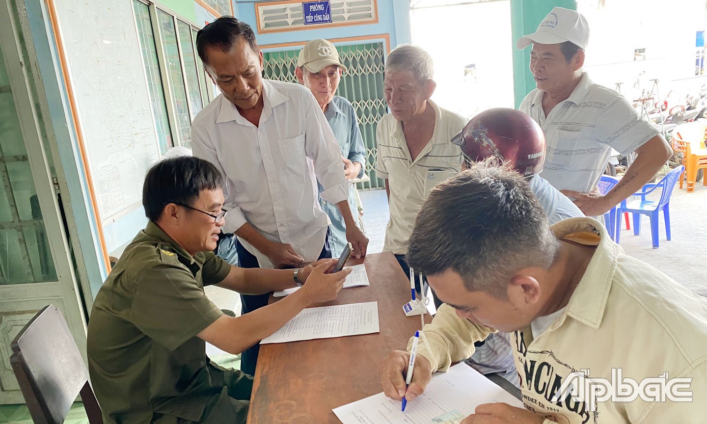 Lực lượng Công an xã Hậu Thành hỗ trợ người dân địa phương cài đặt định danh điện tử VNeID mức độ 2.