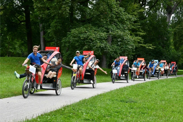 Tourists Ride Electric Bikes in the Park in Munich.webp