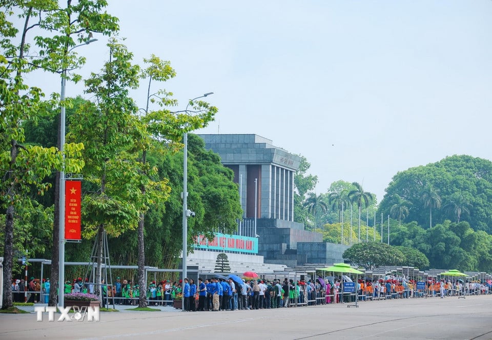 Đông đảo người dân và du khách di chuyển trên đường Hùng Vương để vào Lăng viếng Chủ tịch Hồ Chí Minh sáng 17/5. (Ảnh: Hoàng Hiếu/TTXVN)