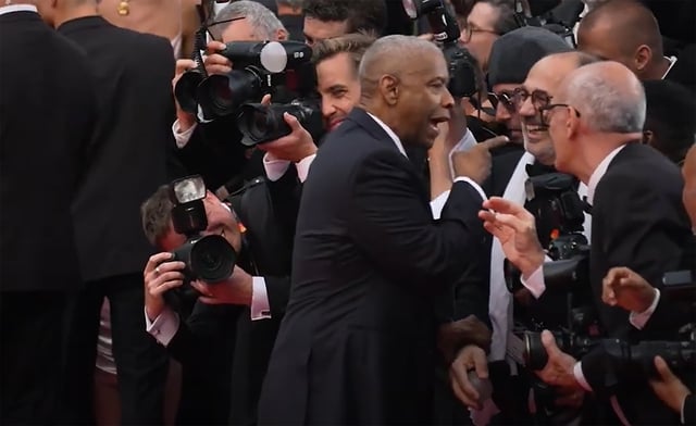 Denzel Washington phản ứng với nhiếp ảnh gia trước khi nhận Cành cọ vàng danh dự- Ảnh 1.
