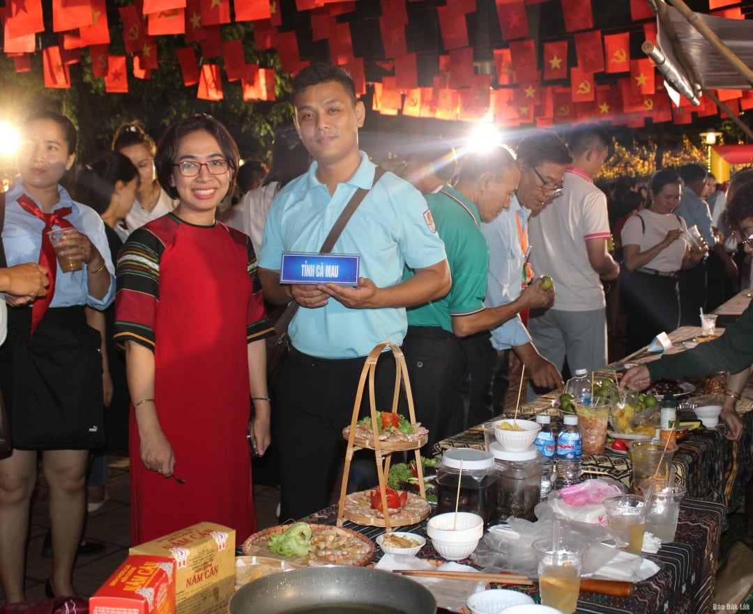 Trưởng Ban tổ chức Liên hoan H’Giang Niê thăm và chụp hình lưu niệm tại gian hàng ẩm thực tỉnh Cà Mau.