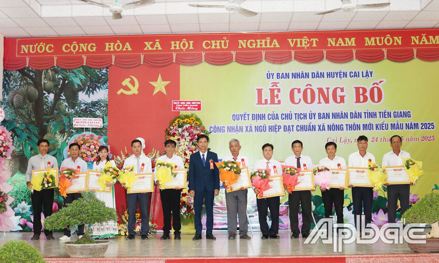 Ông Nguyễn Tấn Nhủ, Bí thư Đảng ủy xã Ngũ Hiệp trao giấy khen cho các cá nhân
