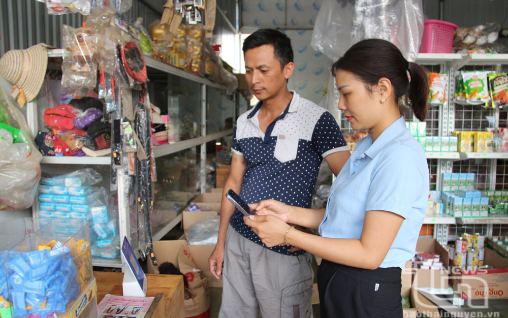Nhiều người dân ở xã Tân Kim (Phú Bình) sử dụng hình thức thanh toán không dùng tiền mặt khi mua hàng hóa. 