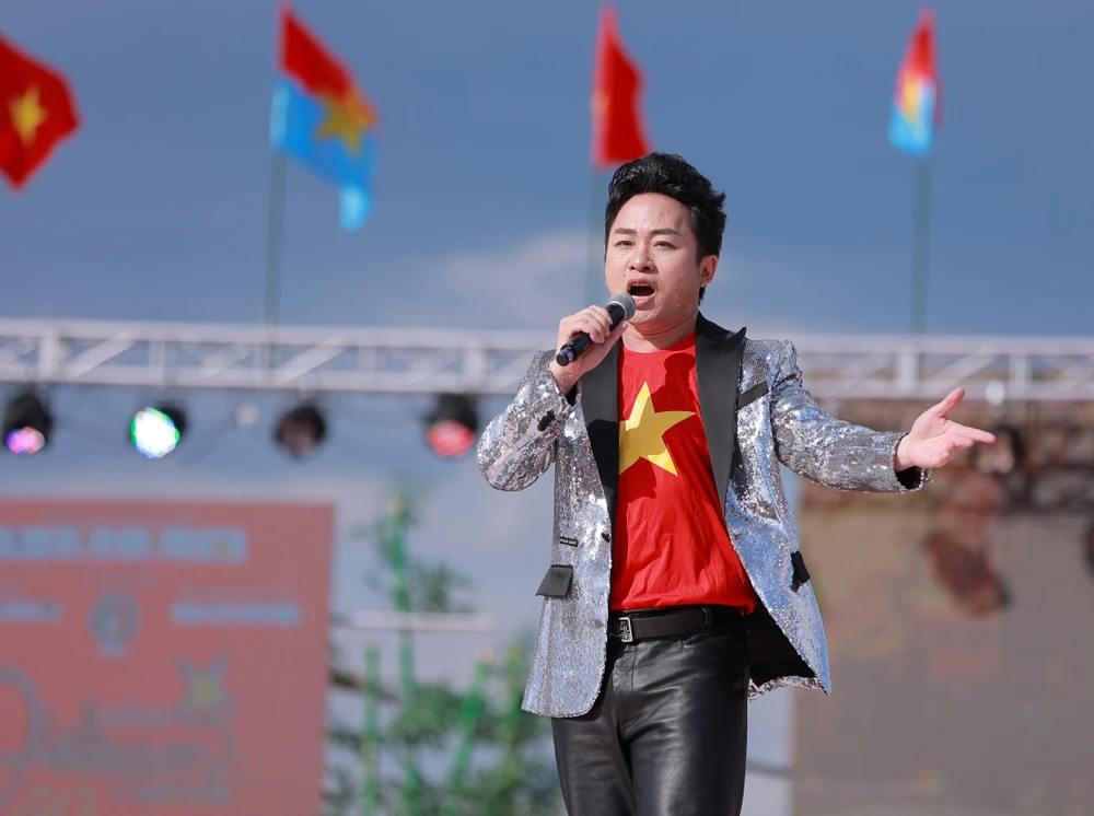 តុង ឌួង ត្រូវ​បាន​ផ្លាស់​ទៅ​ច្រៀង​ភ្លេង​ជាតិ​ក្នុង​ចំណោម​ទង់​ក្រហម​ជាមួយ​នឹង​តារា​ពណ៌​លឿង​នៅ​ប្រទេស​ជប៉ុន។
