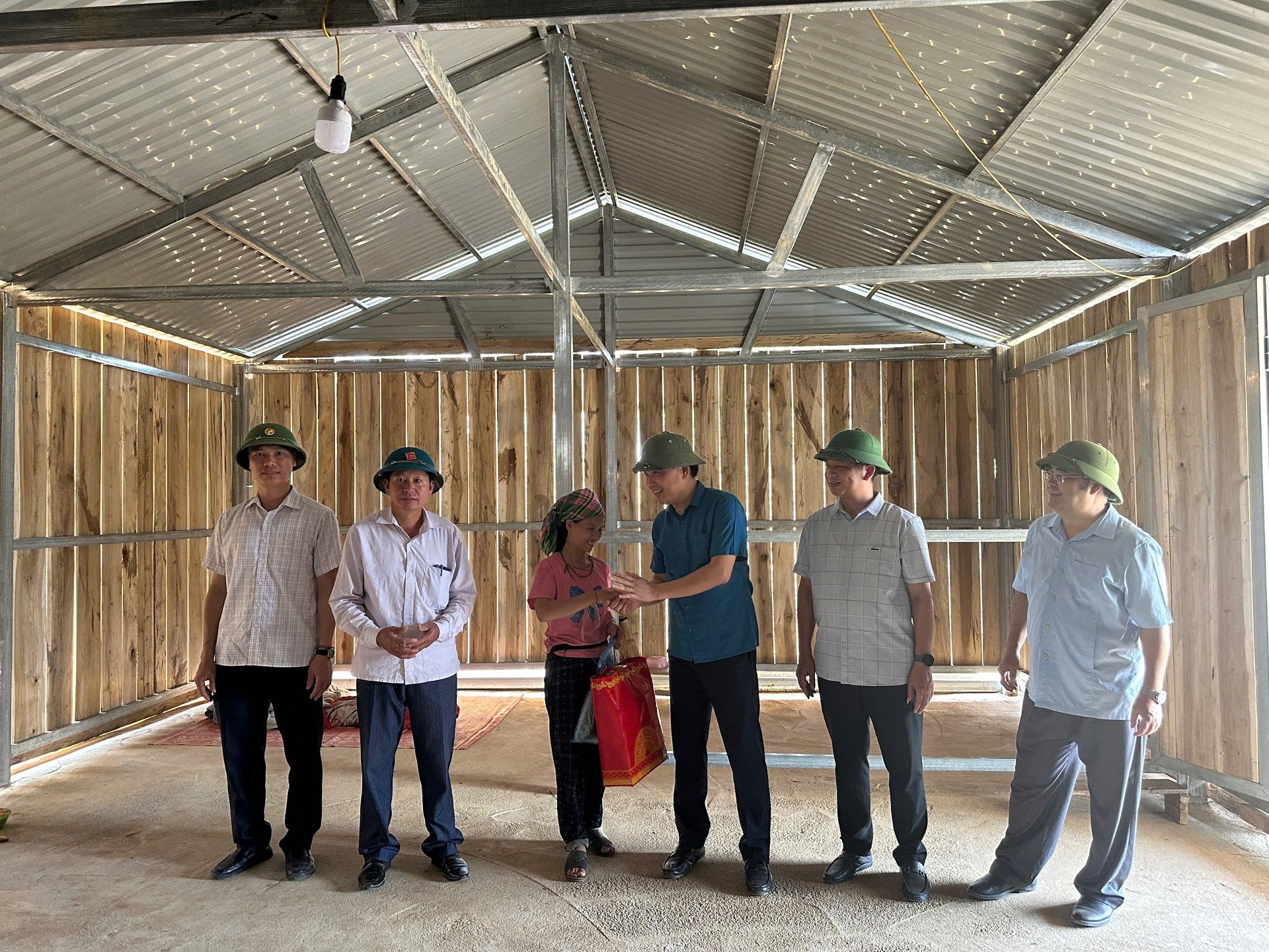 Tổ kiểm tra tặng quà người dân xã Pú Đao thuộc diện được hỗ trợ xóa nhà tạm.