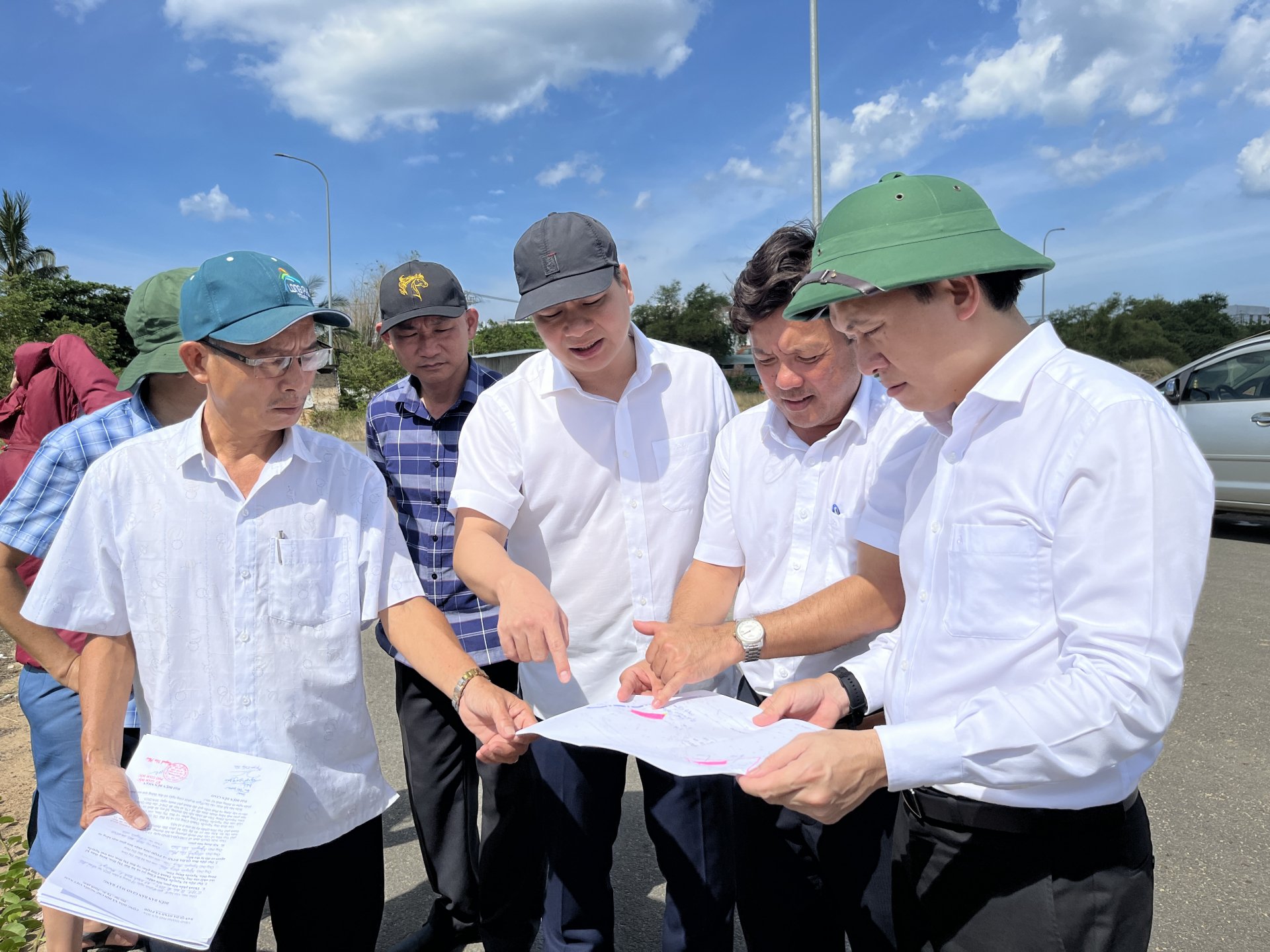 City leaders check and compare actual construction with planning map.