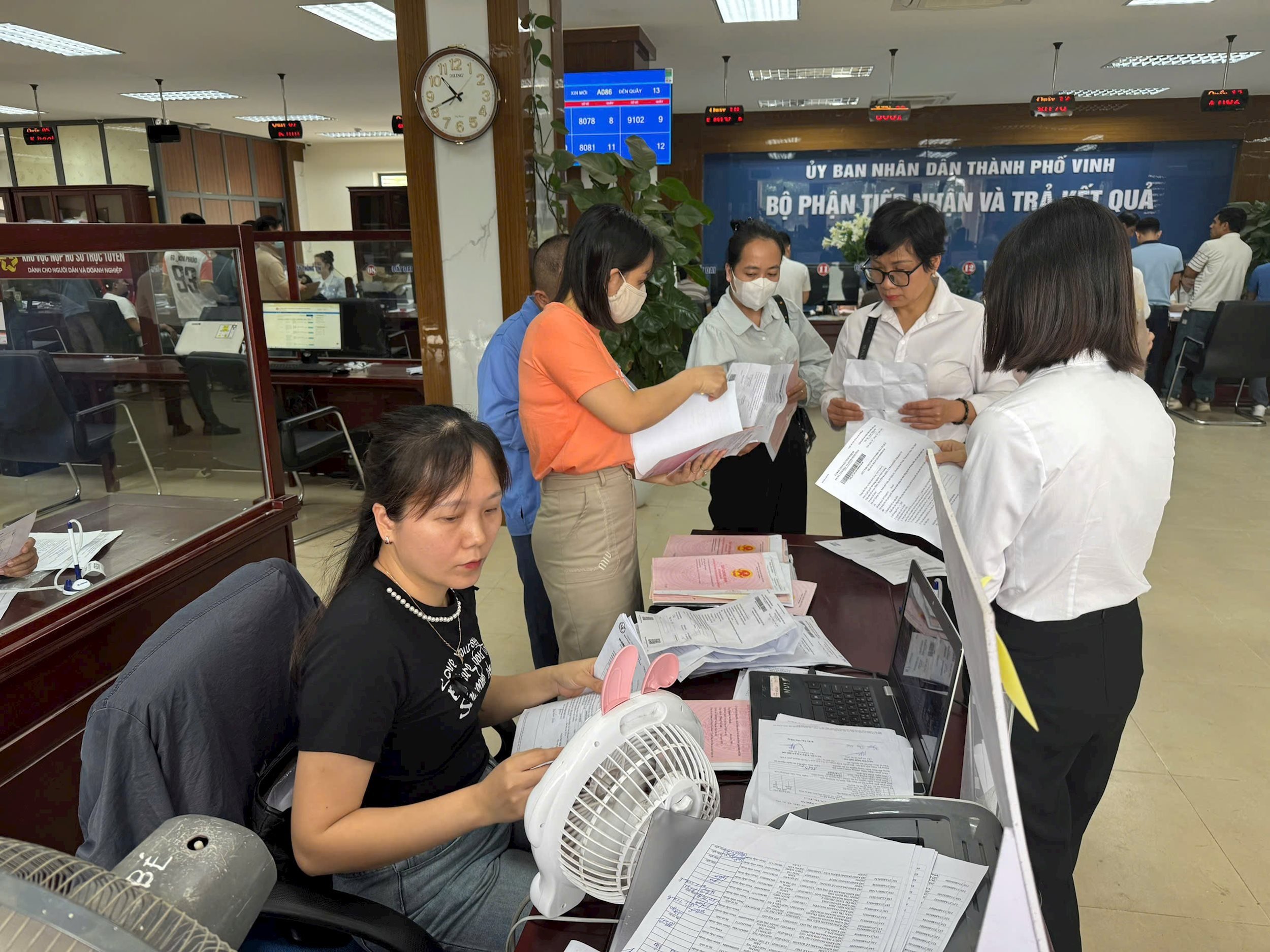 Người dân trực tiếp nhận kết quả xử lý hồ sơ đất đai tại Trung tâm Phục vụ hành chính công TP Vinh. Ảnh Nguyễn Hải