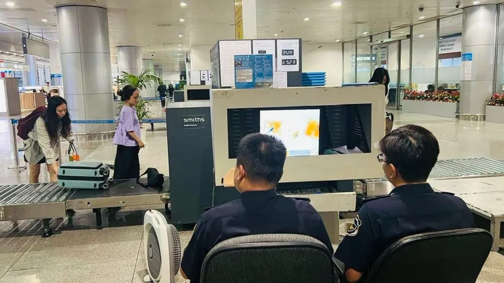 Luggage of people and tourists through customs screening gate at Tan Son Nhat airport