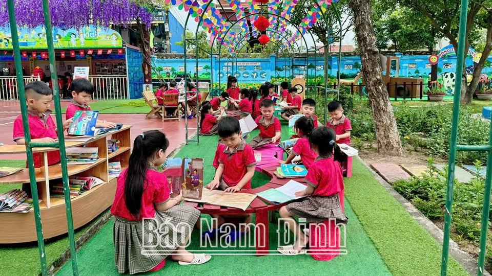 Các cháu Trường Mầm non Nghĩa Sơn (Nghĩa Hưng) đọc sách tại vườn trường.