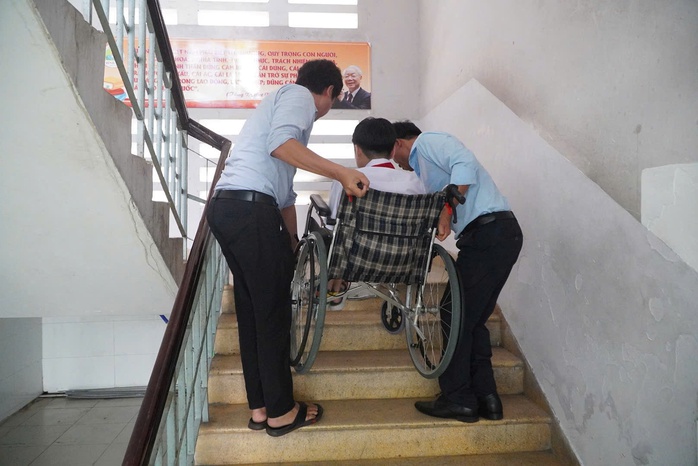Bị teo cơ tủy, nam sinh được cõng vào phòng thi  - Ảnh 1.
