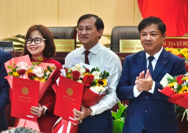 Tân Chủ tịch UBND đặc khu Hoàng Sa (giữa) nhận quyết định và hoa chúc mừng từ Chủ tịch UBND TP.Đà Nẵng Lương Nguyễn Minh Triết (bìa phải). ẢNH: HOÀNG SƠN
