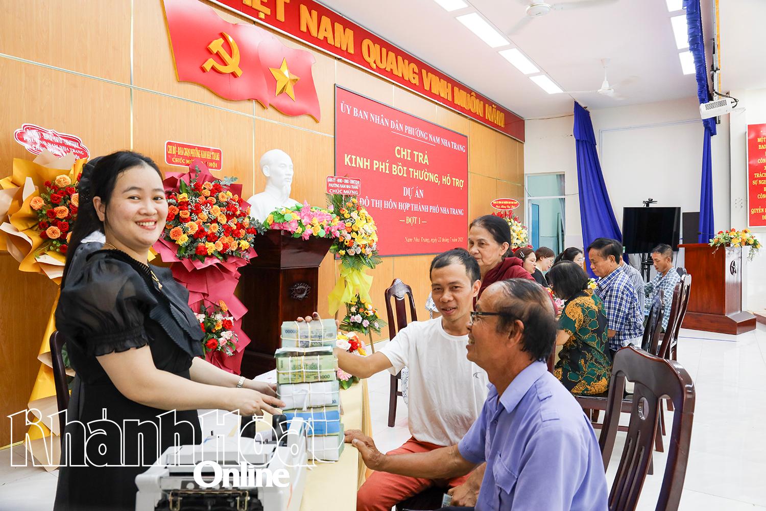 Người dân phấn khởi nhận tiền bồi thường, hỗ trợ.