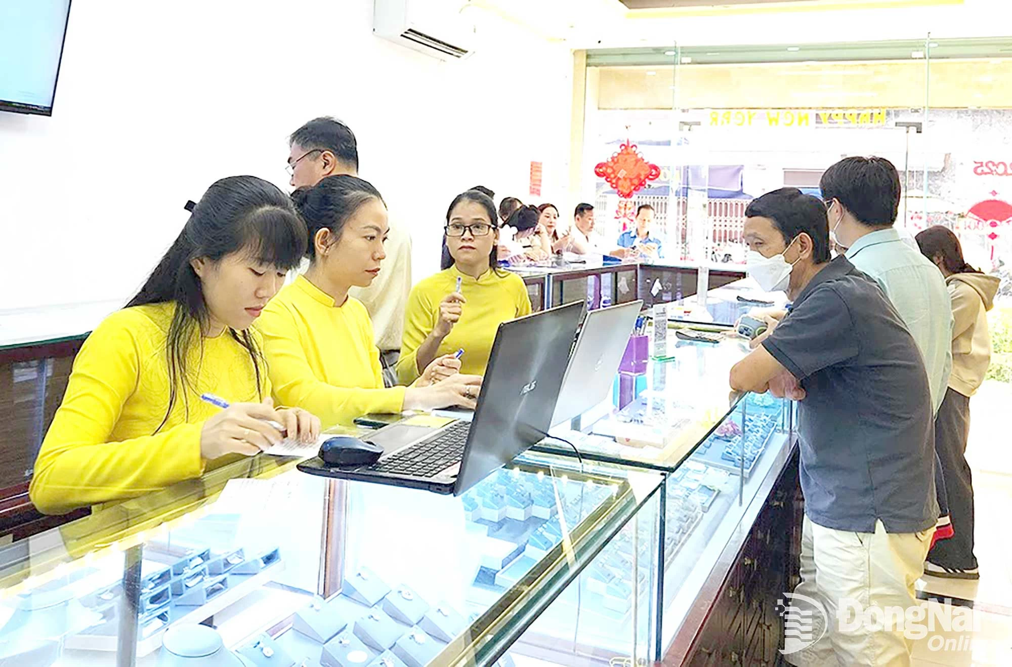 Người dân tham khảo giá các loại vàng miếng, nữ trang vàng tại một trung tâm kim hoàn ở phường Trấn Biên. Ảnh: Hải Quân