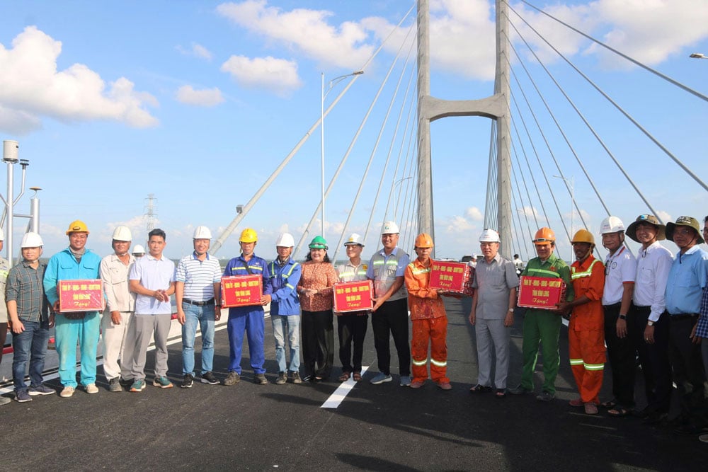 Phó Bí thư Thường trực Tỉnh uỷ- Hồ Thị Hoàng Yến tặng quà cho công nhân trước những nỗ lực hoàn thành vượt tiến độ dự án cầu Rạch Miễu 2.

