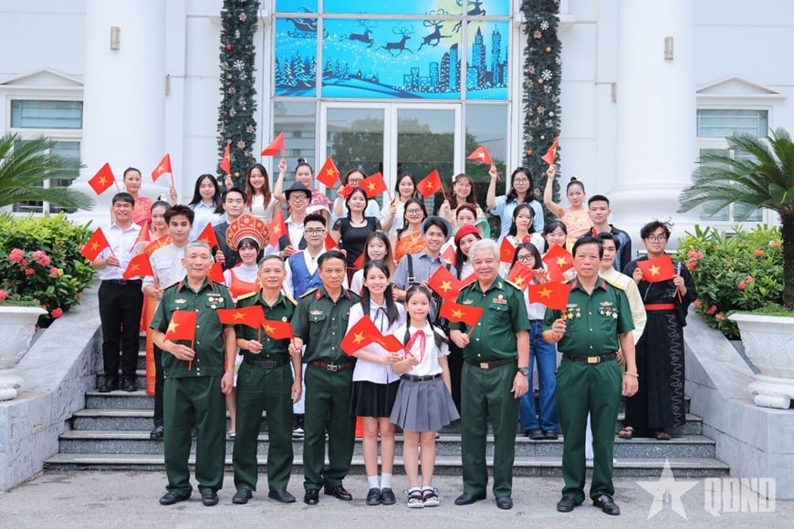 The MV features veterans, teachers, students and pupils.
