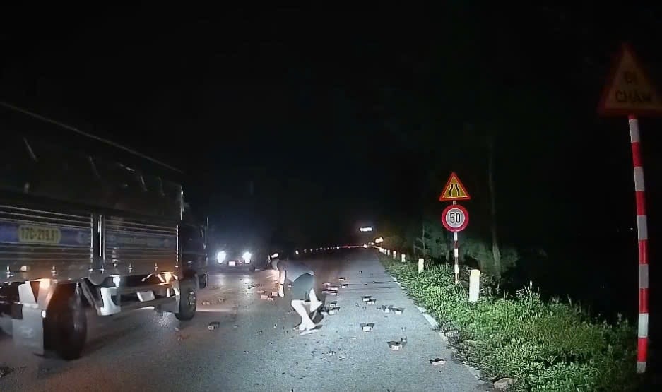 Young man stops car to pick up fallen bricks on North-South axis