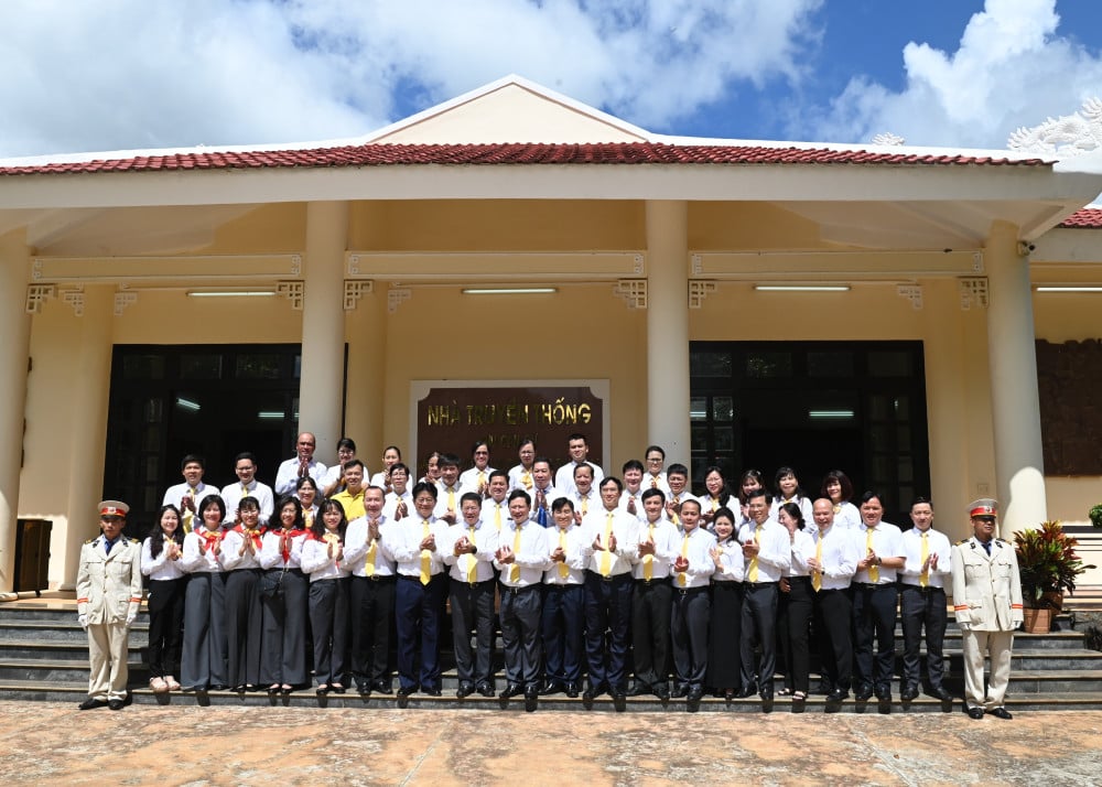 Bộ trưởng Bộ KH&CN Nguyễn Mạnh Hùng chụp ảnh lưu niệm với đội ngũ cán bộ, công chức, viên chức ngành Bưu chính tại Nhà truyền thống Khu Căn cứ Ban GBV và Ban TTLL TWCMN