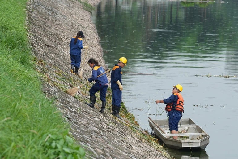 Các công nhân tích cực làm sạch cảnh quan hai bên bờ sông Tô Lịch. (Ảnh: VĂN THỊNH)