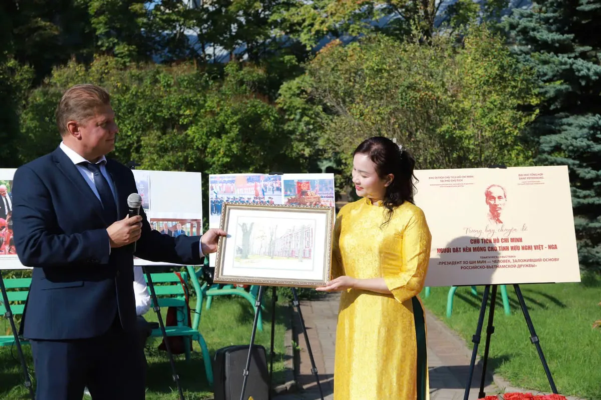 Ông Sergey Andryushin - Phó hiệu trưởng Trường Đại học Quốc gia Saint Petersburg tặng tranh lưu niệm cho bà Lê Thị Phượng, Giám đốc Khu Di tích Chủ tịch Hồ Chí Minh tại Phủ Chủ tịch.
