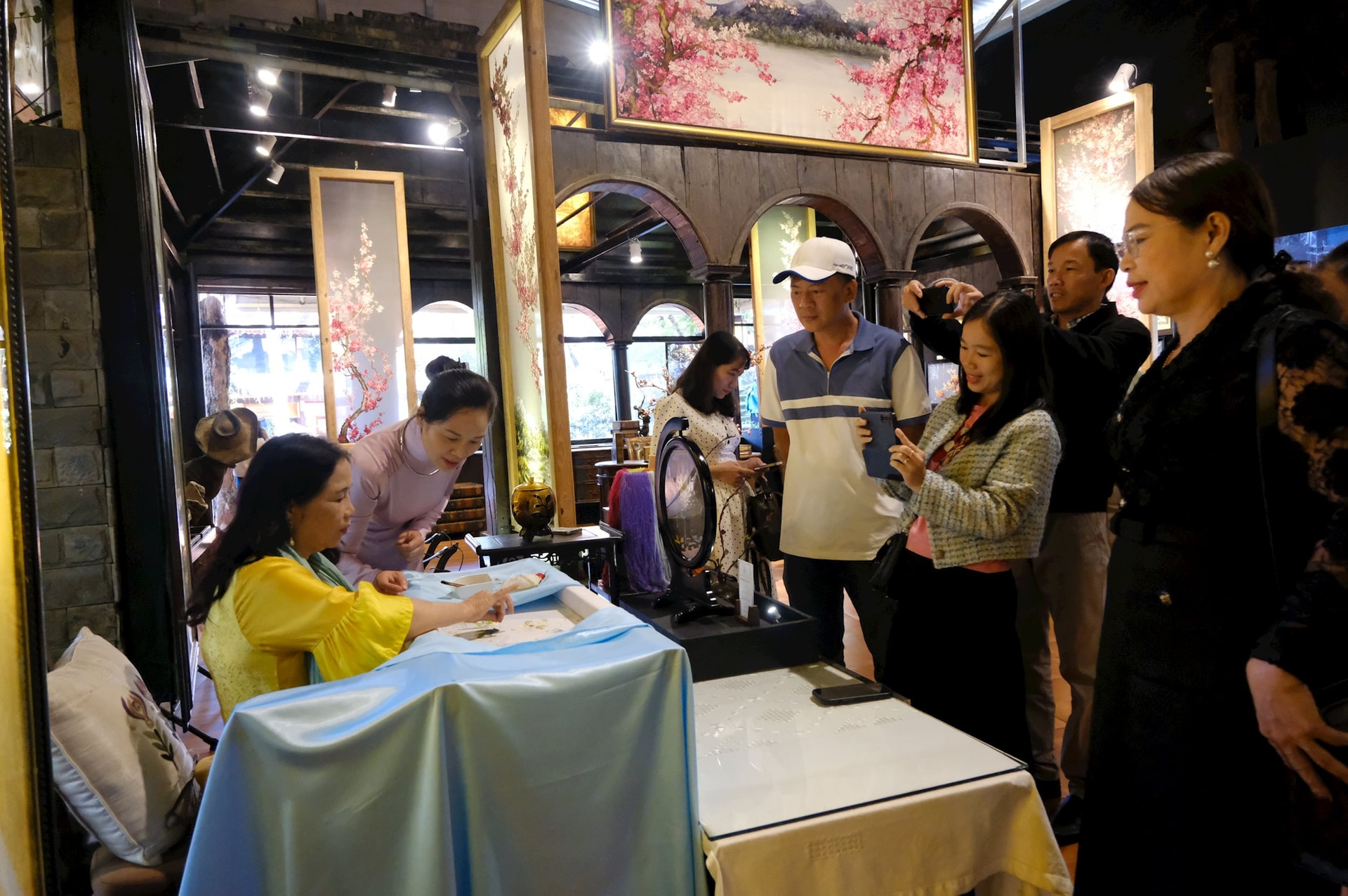 Tourists visit and experience traditional embroidery