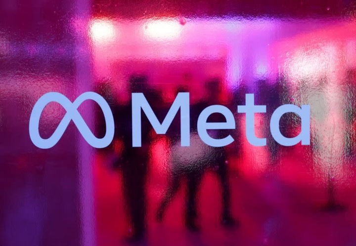 People walk behind the logo of Meta Platforms, a company, during a conference in Mumbai, India. (Source: Reuters)
