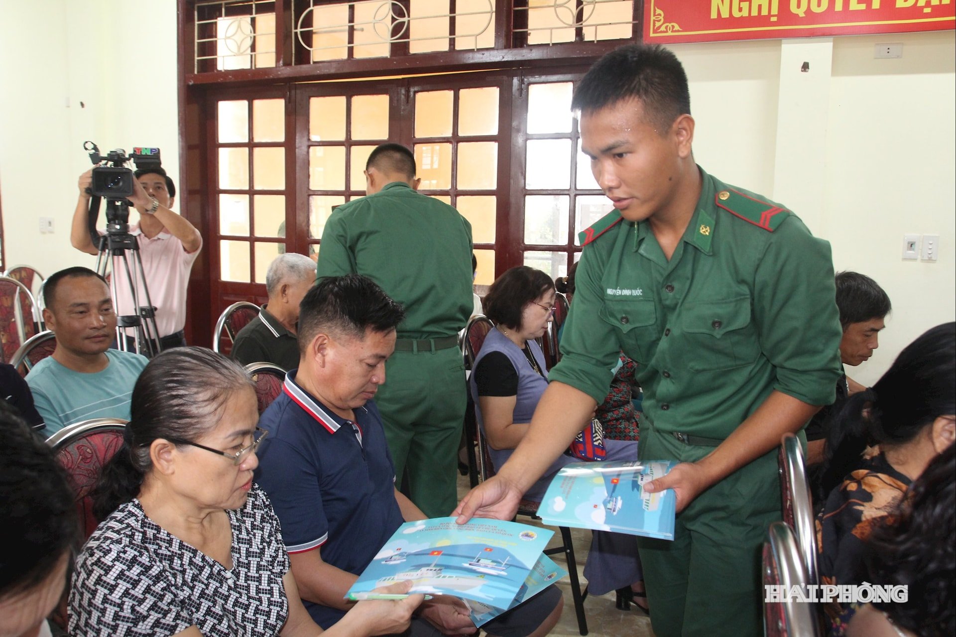 Soldiers of Do Son Border Guard Station distribute propaganda leaflets to fishermen.