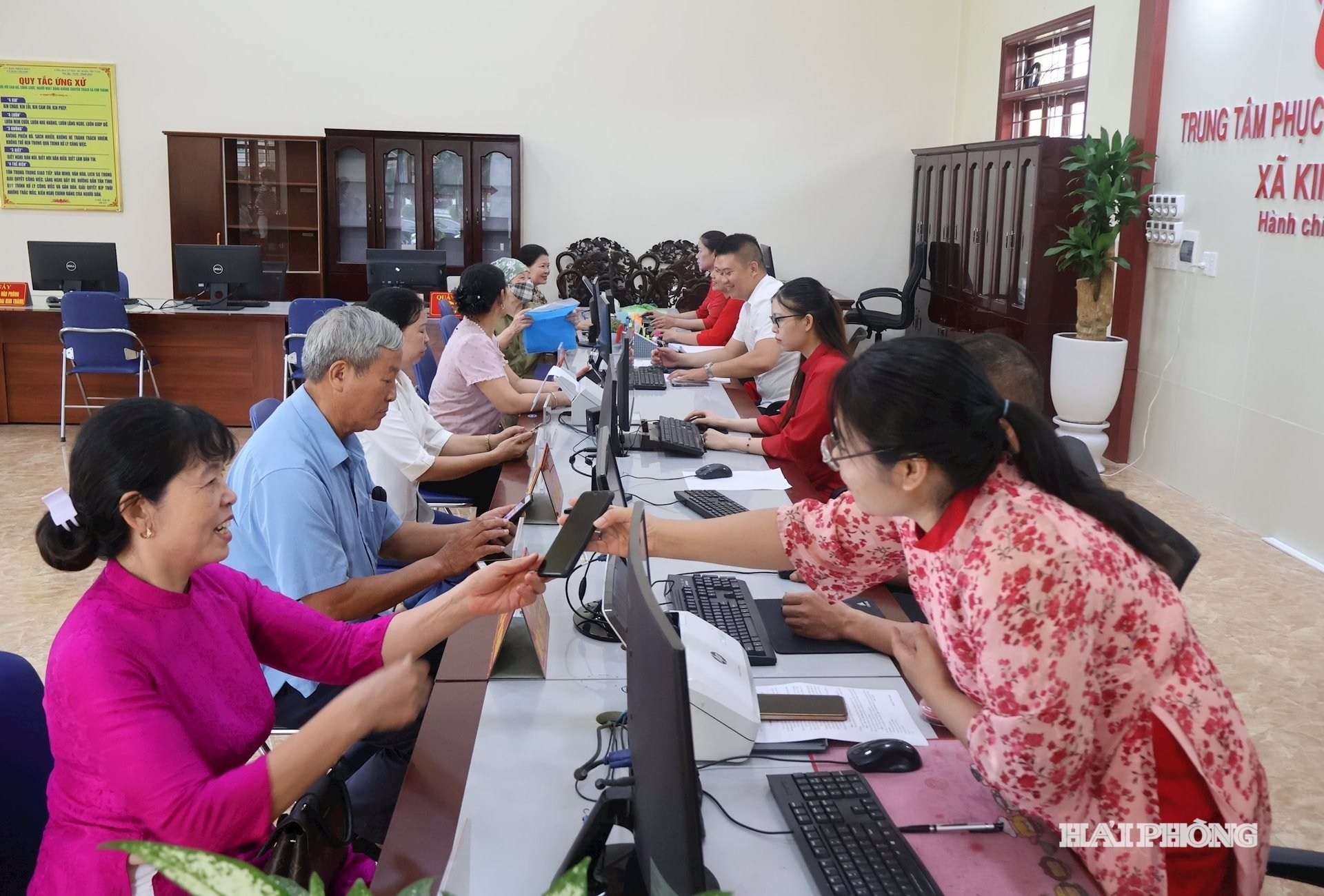 Công chức xã Kim Thành hướng dẫn người dân đăng nhập vào Cổng Dịch vụ Công quốc gia để giải quyết thủ tục hành chính trực tuyến. Ảnh: TRƯƠNG HÀ