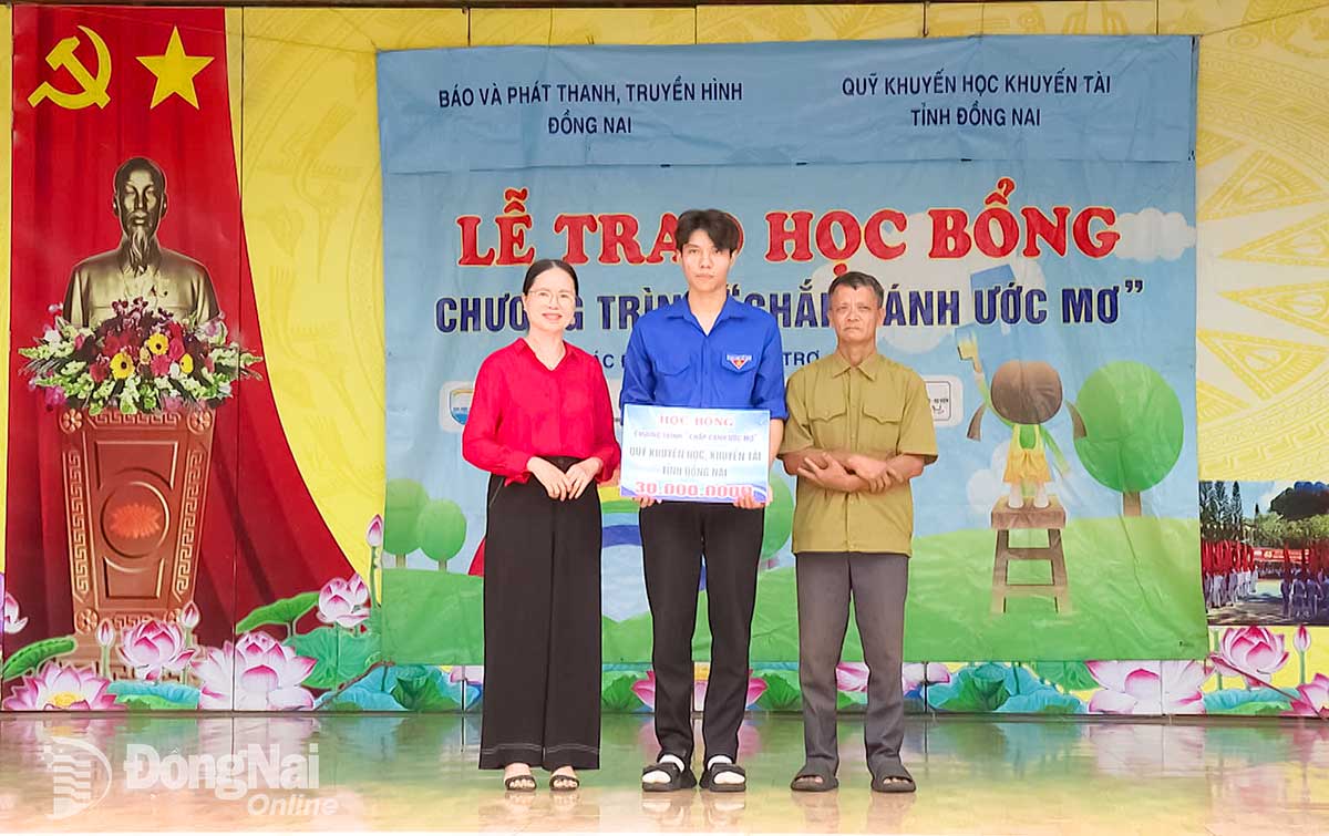 លោកស្រី Trinh Thi Tam អនុប្រធានសមាគមលើកកម្ពស់ការអប់រំខេត្ត Dong Nai បានផ្តល់អាហារូបករណ៍ពីមូលនិធិលើកកម្ពស់ការអប់រំ ដែលមានតម្លៃ ៣០លានដុង។ រូបថត៖ ភូគី 