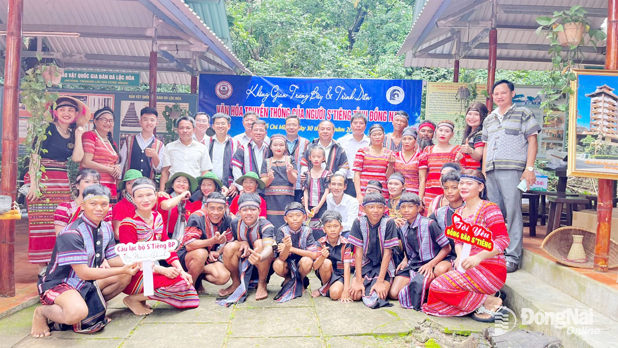 People visit and take photos with members of the Binh Phuoc Stieng Cultural Club at the Cu Chi Tunnels historical site, Ho Chi Minh City.
