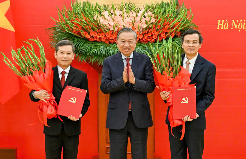 Le secrétaire général To Lam remet la décision du Politburo et des fleurs pour féliciter les camarades Le Minh Tri et Doan Minh Huan. (Photo : DUY LINH)