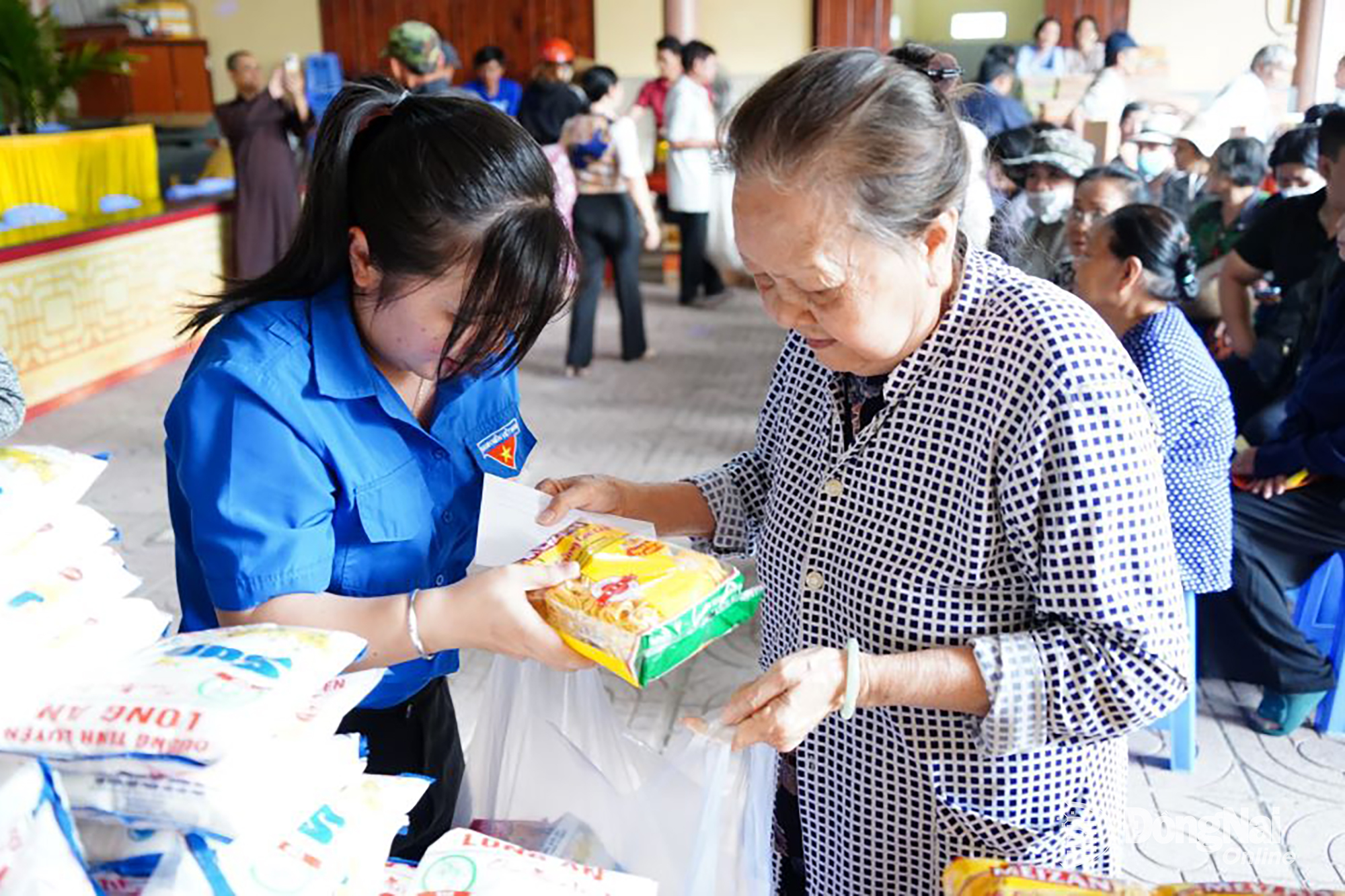 Tình nguyện viên hỗ trợ phát quà cho người dân có hoàn cảnh khó khăn tại phường Tân Triều. Ảnh: Lê Duy