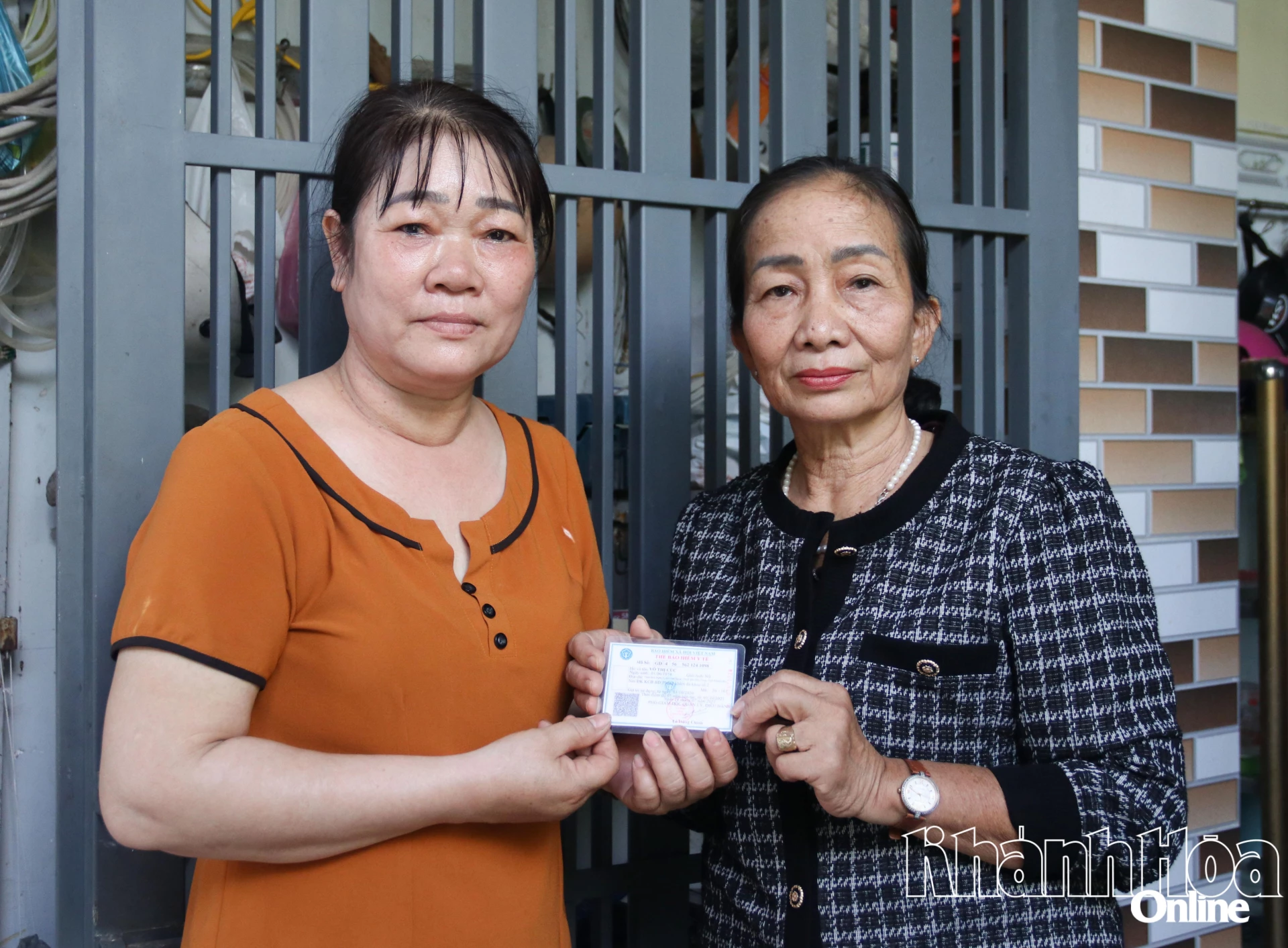 Ms. Hoa (on the right) presents health insurance cards to women in particularly difficult circumstances.