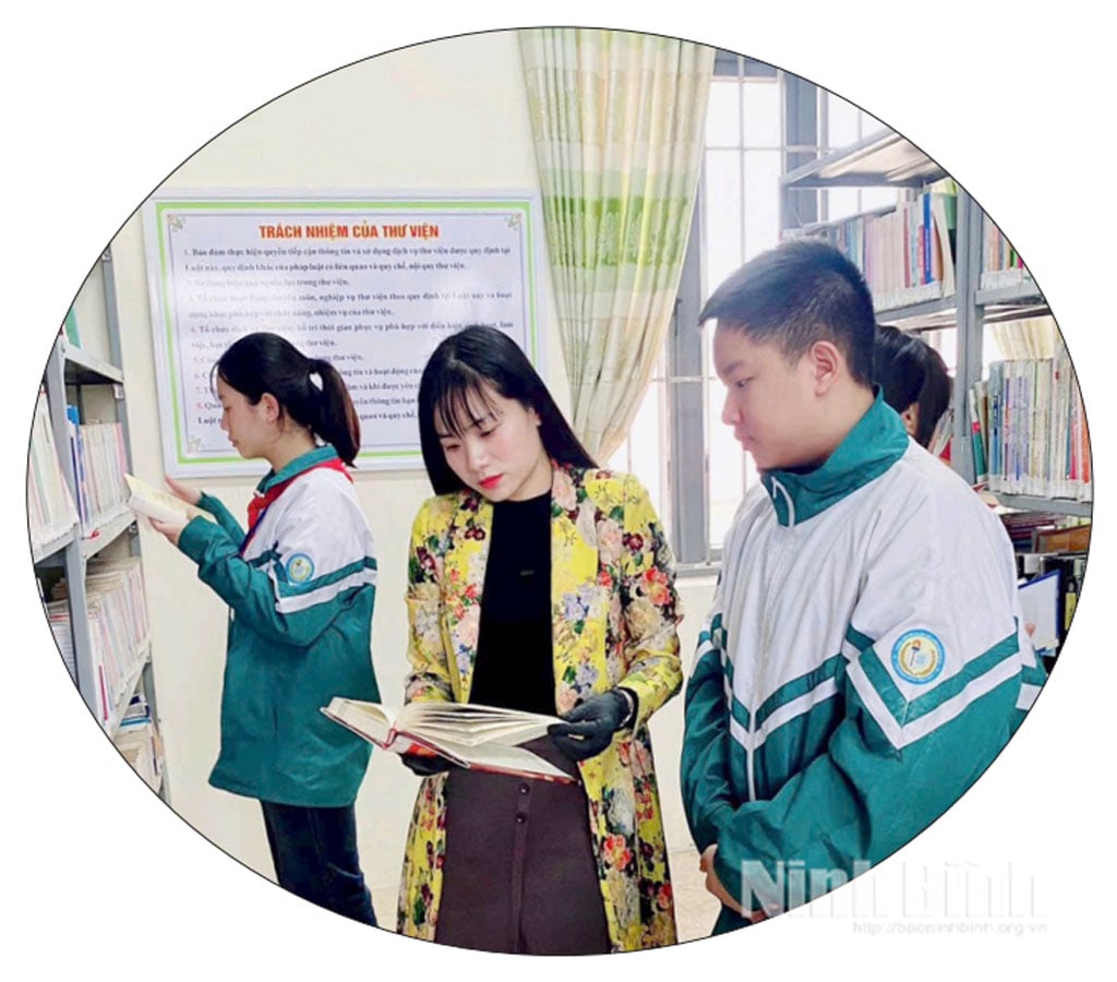 Guru dan siswa Sekolah Menengah Tan Hiep (Kelurahan Ha Nam) berkonsultasi dengan buku dan bahan ajar di perpustakaan sekolah.