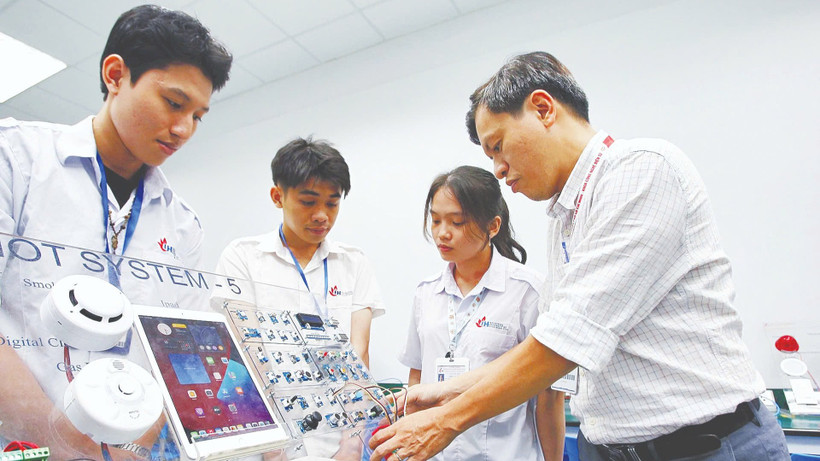 Giảng viên Khoa công nghệ điện tử Trường đại học Công nghiệp Thành phố Hồ Chí Minh hướng dẫn sinh viên học tập, nghiên cứu tại Phòng thí nghiệm IoT and AI. (Ảnh: THANH VŨ)