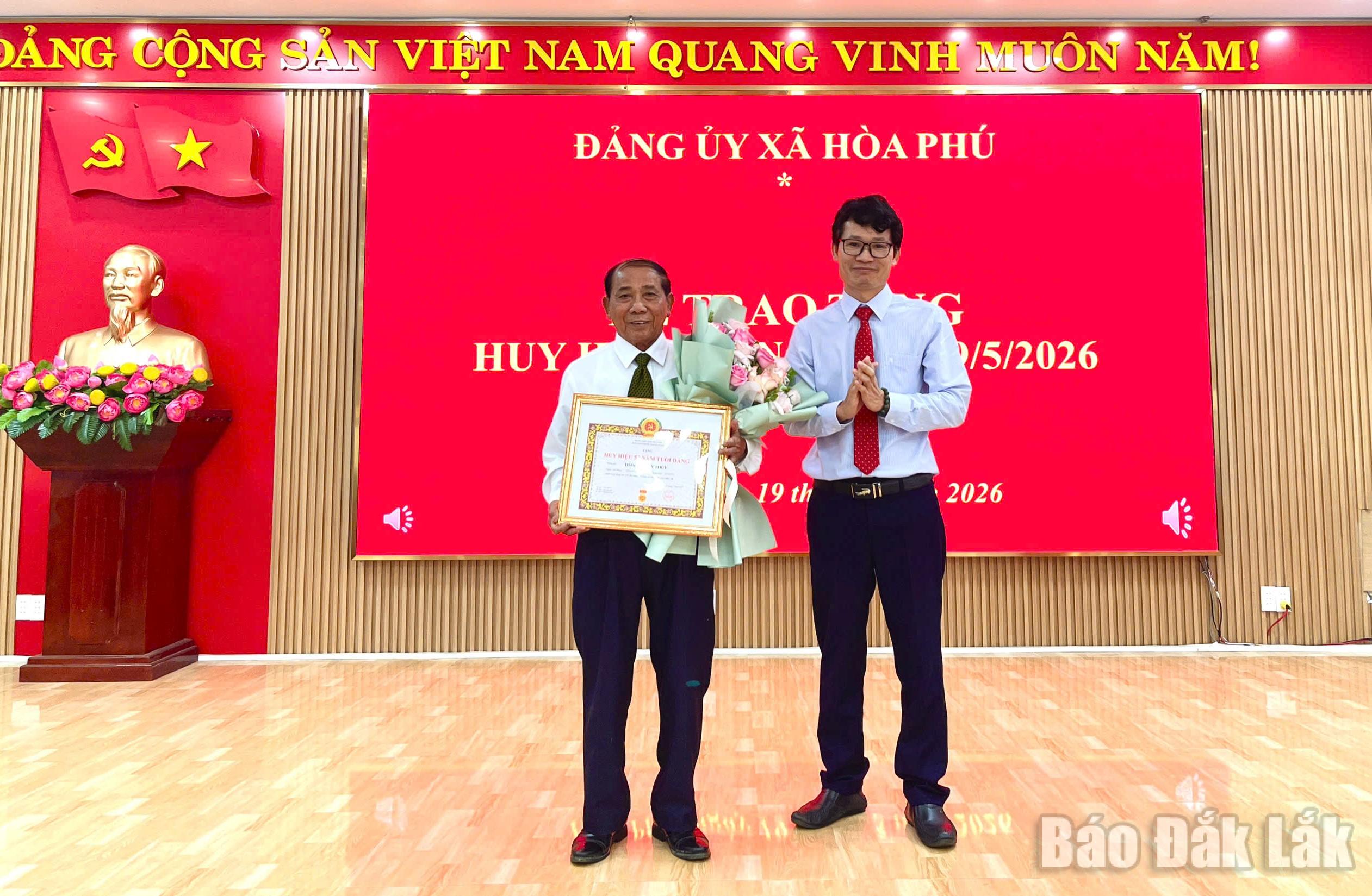 Chủ tịch UBND xã Hòa Phú Nguyễn Thế Hậu trao Huy hiệu Đảng cho đảng viên thuộc Đảng bộ xã.