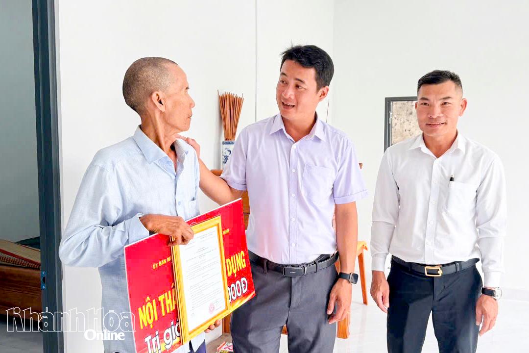 Lãnh đạo xã Vạn Ninh thăm hỏi ông Nguyễn Văn Thui tại lễ bàn giao nhà Đại đoàn kết.