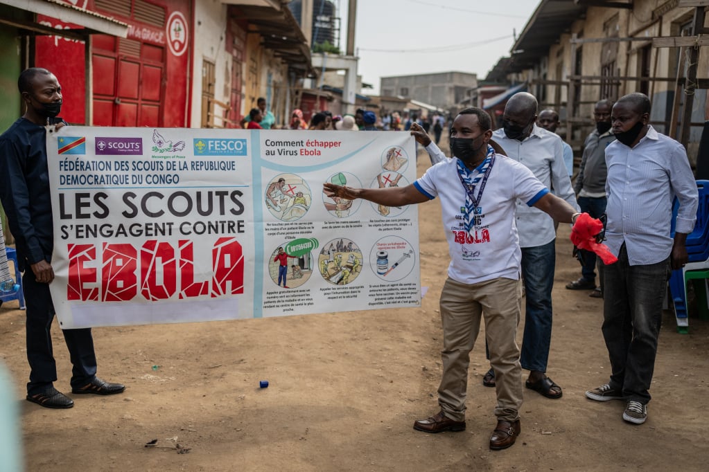 Volunteers carry signs raising awareness about the Ebola outbreak during a community outreach campaign in Bunia, Democratic Republic of Congo. Photo: AP.