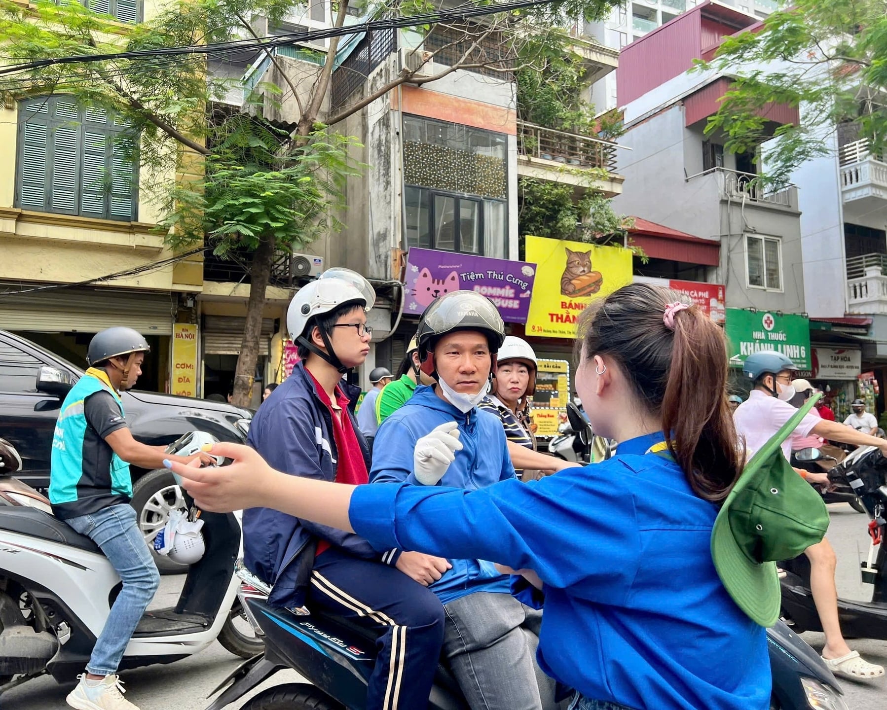 Đội hình thanh niên tình nguyện phường Ngọc Hà hướng dẫn phụ huynh, hỗ trợ phân luồng giao thông quanh điểm thi lớp 10. Ảnh: Lan Chi.