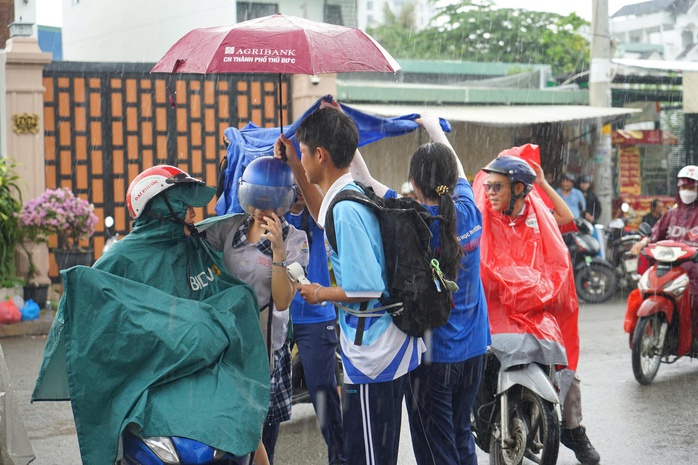 Mưa bất chợt, học sinh vẫn đội mưa tiếp sức thí sinh - Ảnh 1.