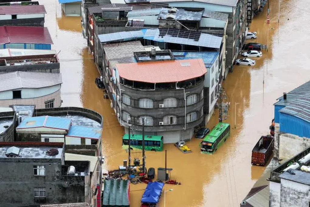 Heavy rains cause dam breach, China issues flood warning.